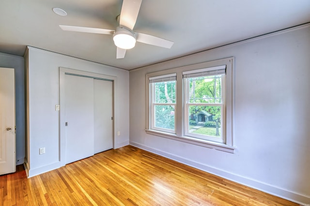 unfurnished bedroom with a closet, light hardwood / wood-style floors, and ceiling fan