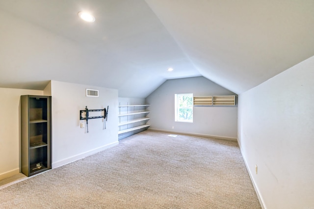 additional living space with carpet flooring and vaulted ceiling