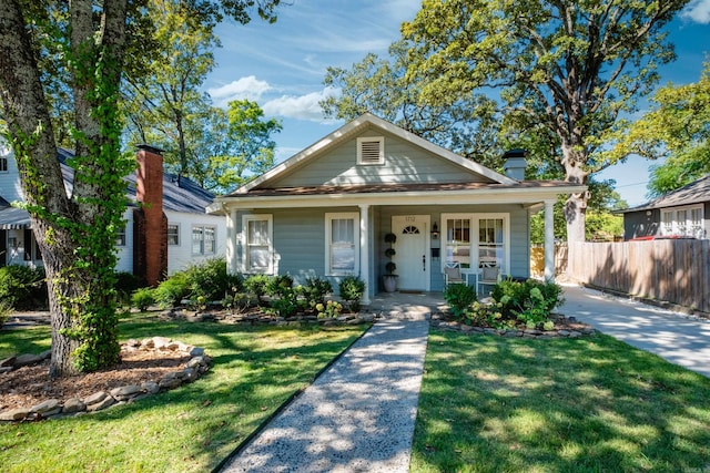 bungalow-style house featuring a porch and a front lawn