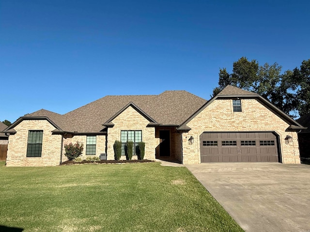 view of front of home with a garage and a front yard