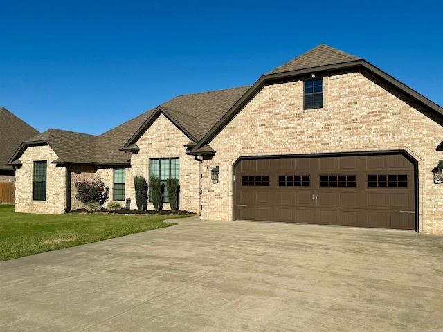 view of front of property with a garage and a front lawn