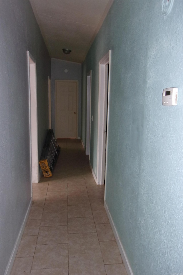 corridor with light tile patterned floors