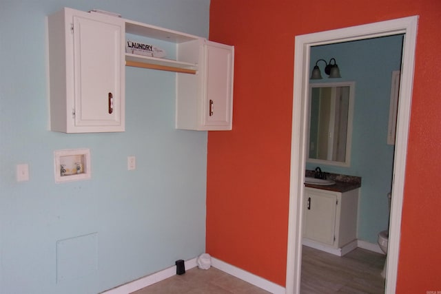3058 Rocky Ridge Rd, Mountain Home, AR 72653 - washroom featuring a sink, hookup for a washing machine, and baseboards