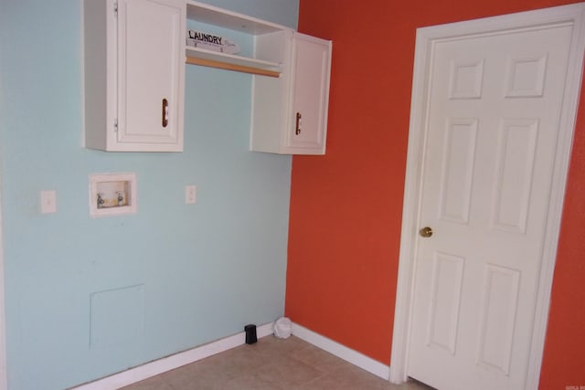 washroom featuring cabinets, washer hookup, and light tile patterned floors