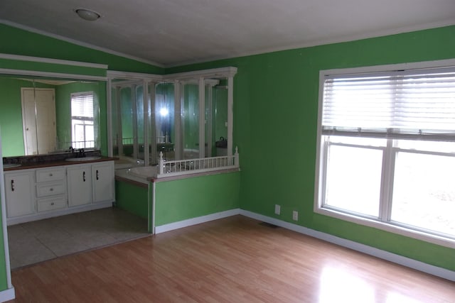 3058 Rocky Ridge Rd, Mountain Home, AR 72653 - spare room featuring crown molding, light wood-style flooring, a sink, lofted ceiling, and baseboards