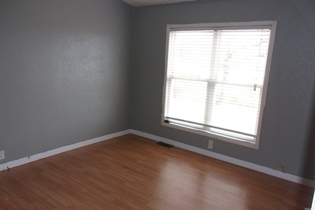 empty room featuring hardwood / wood-style floors