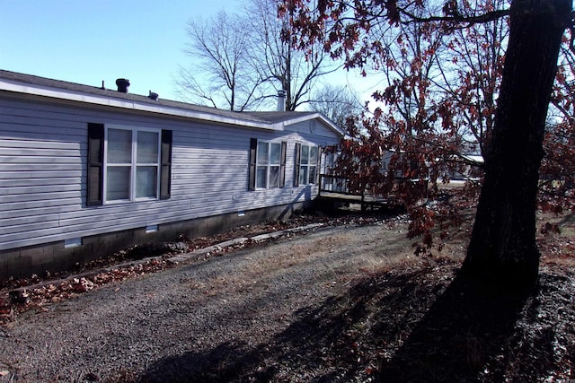 view of home's exterior featuring a wooden deck