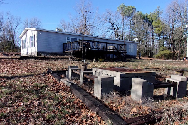 rear view of house featuring a deck