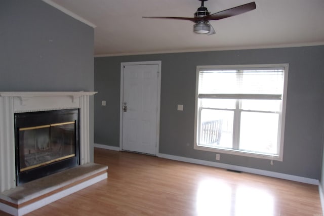 unfurnished living room with crown molding, light hardwood / wood-style floors, and ceiling fan