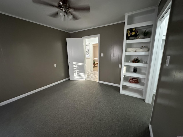 unfurnished bedroom featuring ornamental molding, a ceiling fan, carpet, and baseboards