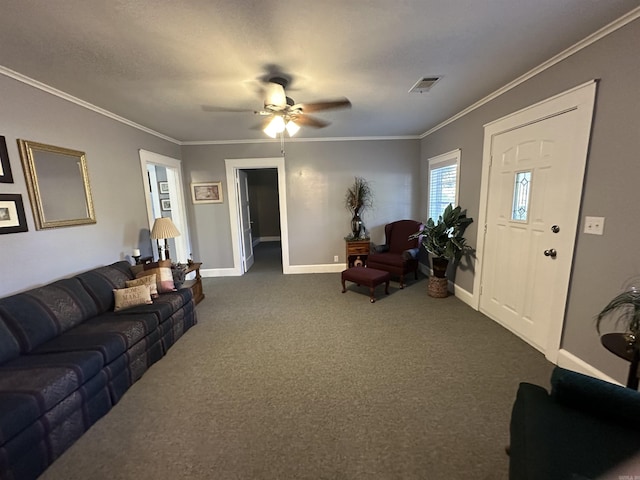 living area with dark carpet, visible vents, a ceiling fan, and ornamental molding