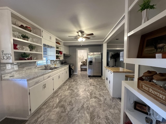 kitchen featuring a sink, stainless steel appliances, open shelves, a ceiling fan, and white cabinetry