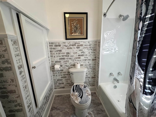 bathroom featuring shower / bath combo with shower curtain and toilet