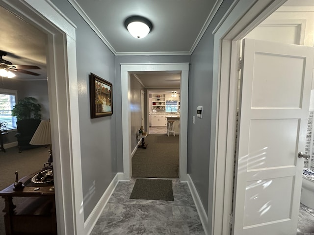 hall featuring ornamental molding and baseboards