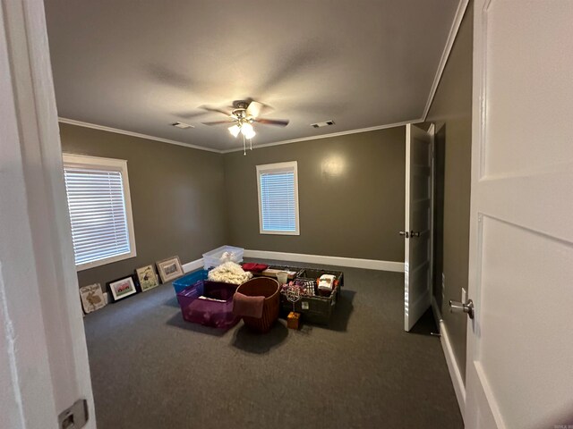 game room featuring ceiling fan, ornamental molding, and carpet flooring