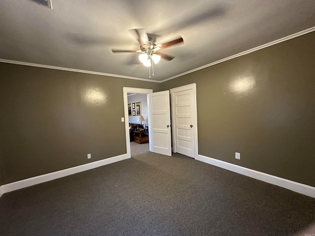 unfurnished bedroom featuring dark carpet, ceiling fan, ornamental molding, and a textured ceiling