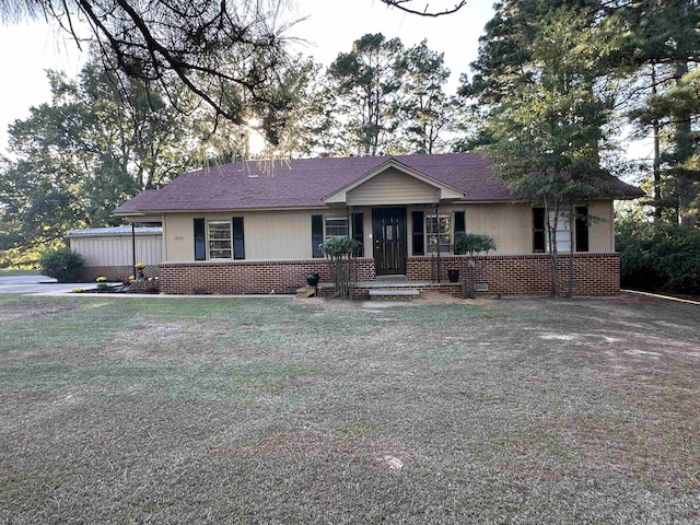 ranch-style house with a front lawn and brick siding