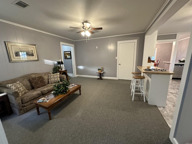 living area with a ceiling fan, visible vents, baseboards, ornamental molding, and carpet floors
