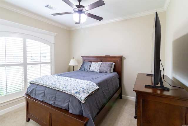 carpeted bedroom with ceiling fan and ornamental molding