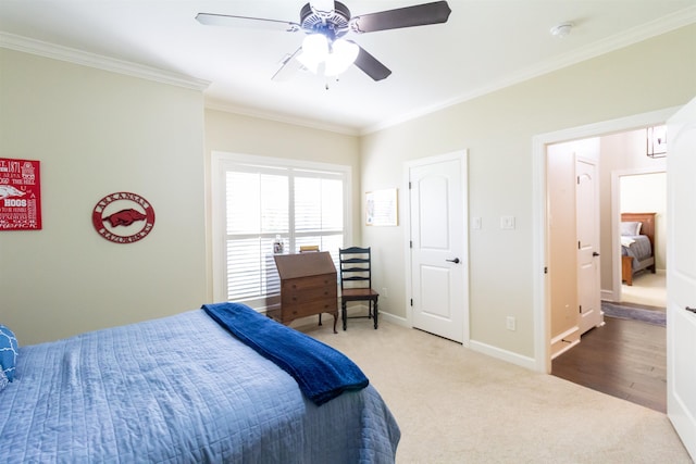 bedroom with carpet, crown molding, and ceiling fan