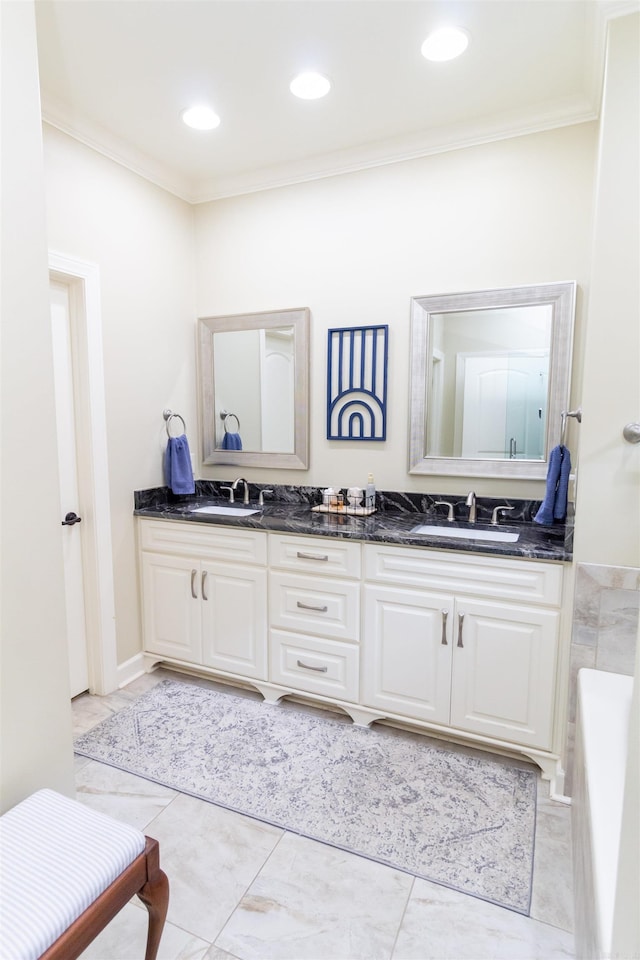 bathroom with a bathtub, crown molding, and vanity