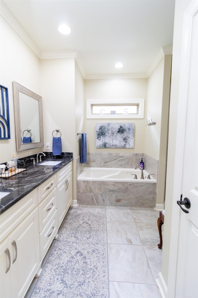 bathroom with ornamental molding, tiled tub, and vanity