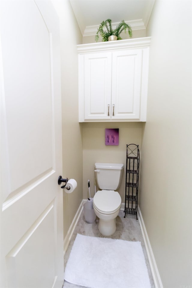 bathroom with crown molding and toilet