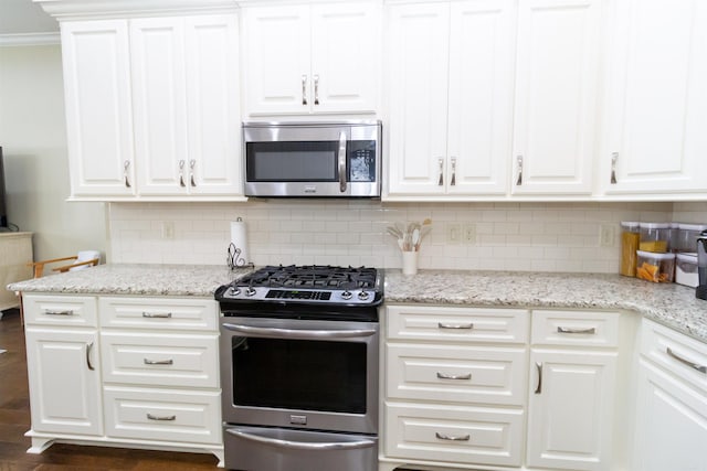 kitchen featuring light stone countertops, white cabinets, and appliances with stainless steel finishes