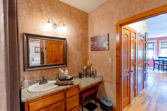 bathroom with vanity and hardwood / wood-style floors