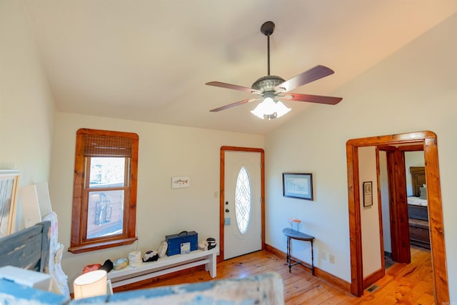 entryway featuring vaulted ceiling, ceiling fan, and light hardwood / wood-style flooring