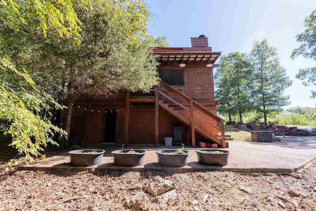 6 Aviation Way, Heber Springs, AR 72543 - back of property featuring a patio area, an outdoor fire pit, a chimney, and stairs