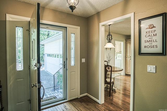 entryway featuring a textured ceiling and dark hardwood / wood-style flooring