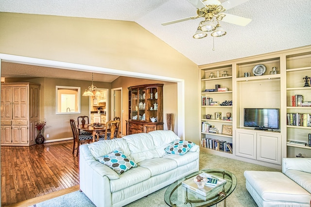 living room featuring a textured ceiling, light hardwood / wood-style floors, vaulted ceiling, and ceiling fan