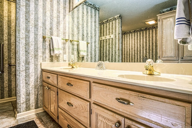 bathroom with a textured ceiling and vanity