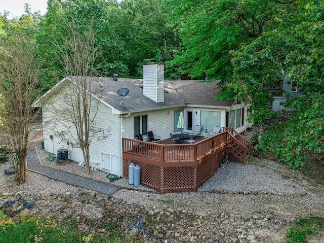 back of property featuring central AC and a deck