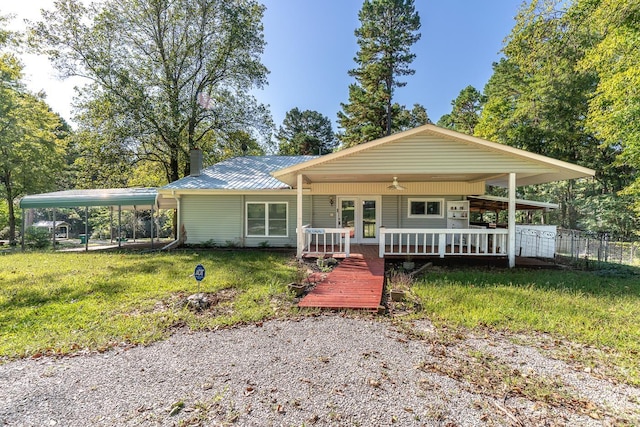 ranch-style house with a carport, a front lawn, and a wooden deck