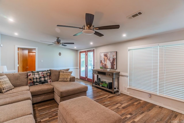 living room with ceiling fan and dark hardwood / wood-style floors