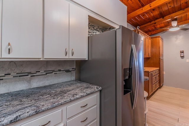 kitchen with stainless steel fridge, light hardwood / wood-style floors, white cabinets, wooden ceiling, and beam ceiling