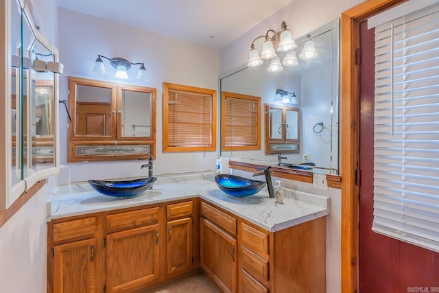 bathroom featuring a notable chandelier and vanity