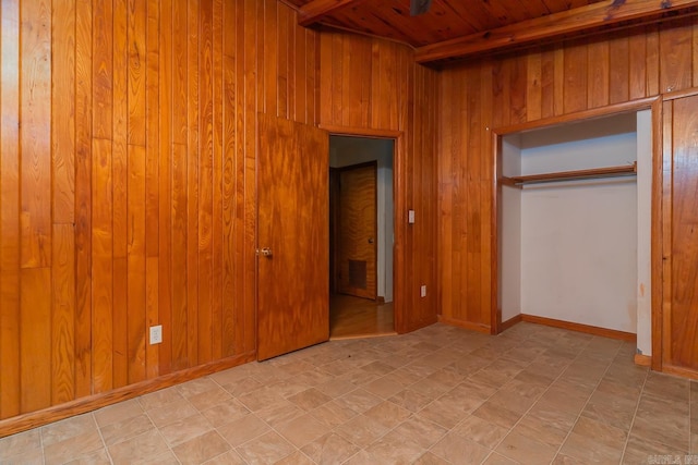 unfurnished bedroom featuring wooden walls, a closet, and wooden ceiling