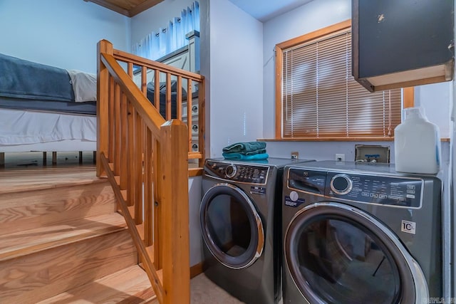 laundry room featuring wood-type flooring and washing machine and clothes dryer