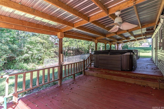 deck with a hot tub and ceiling fan