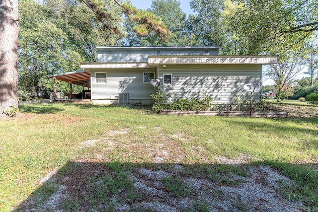 rear view of property featuring a yard and central AC