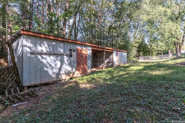 view of outbuilding with a lawn