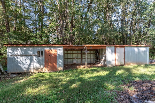 view of outbuilding featuring a lawn