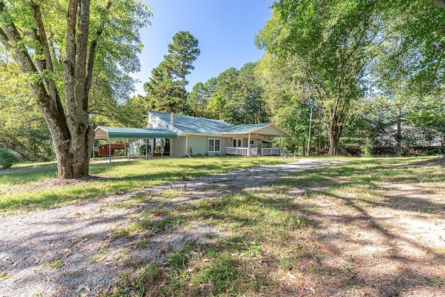 view of yard with a carport and a porch