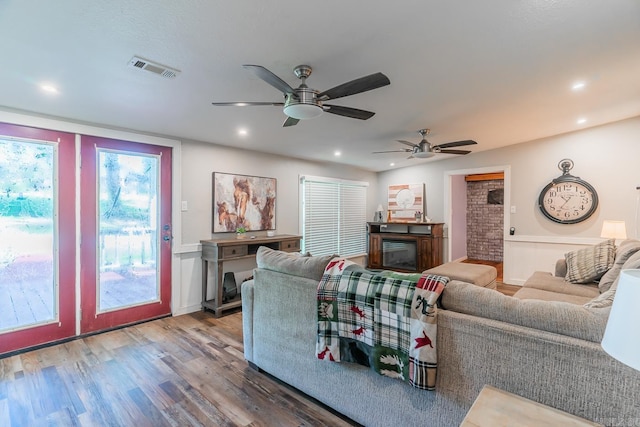 living room with ceiling fan and hardwood / wood-style flooring