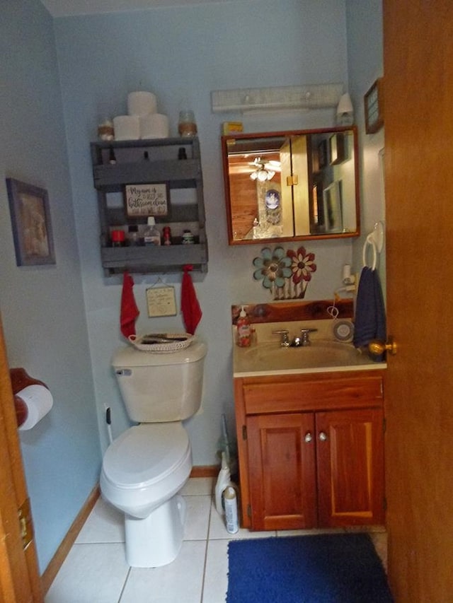 bathroom with ceiling fan, vanity, tile patterned flooring, and toilet