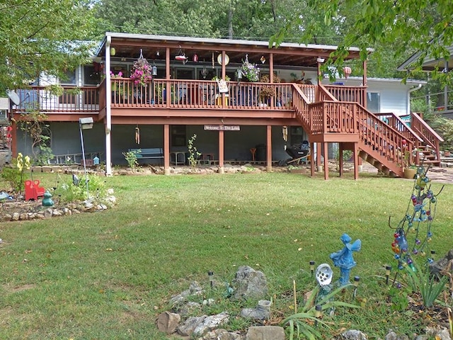 rear view of house with a wooden deck and a yard