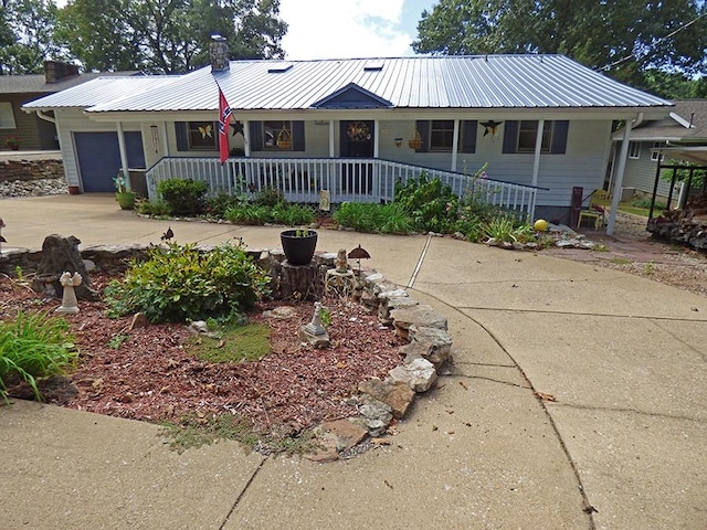 ranch-style house with a garage and covered porch